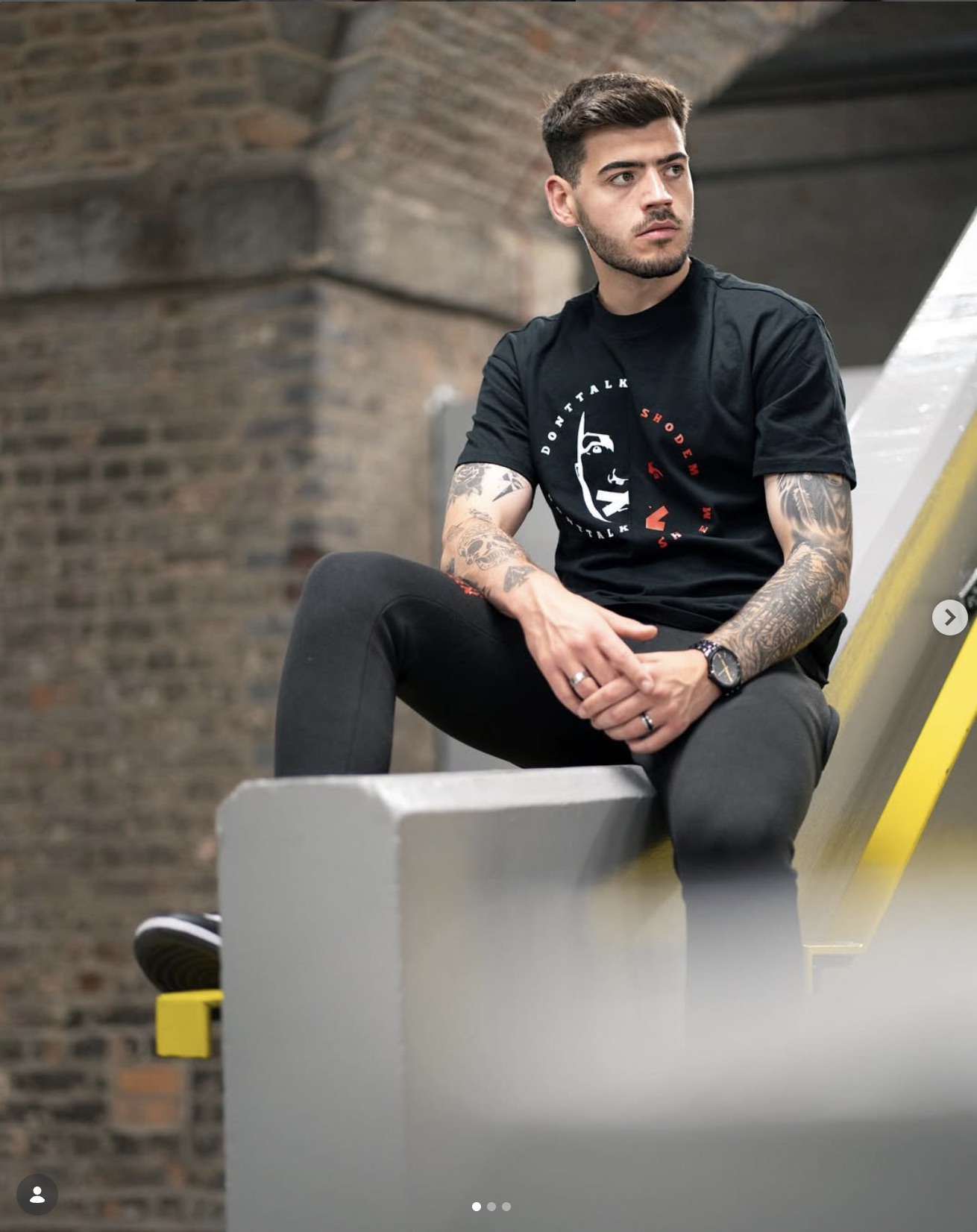 Donttalkshodem — Circular face graphic and typography on a black T-shirt